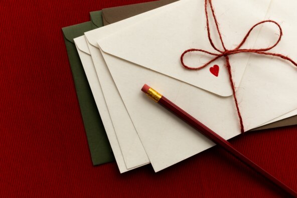 kaboompics_love-letter-envelopes-with-red-string-and-pencil-on-red-background-42529.jpg